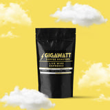 Gigawatt Coffee Live Wire Espresso Blend, bestselling dark roast espresso coffee. Perfect for espresso lovers. 3 oz coffee sampler pack, set against a cloud-filled background.