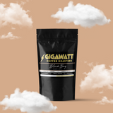 Gigawatt Coffee Black Bag Series, limited release special single origin coffees. 3 oz coffee sampler pack, set against a cloud-filled background.