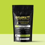 Gigawatt Coffee Organic Honduran Coffee, freshly roasted small batch, medium light roast with smooth taste and blueberry hints. 10 oz, displayed on a counter.