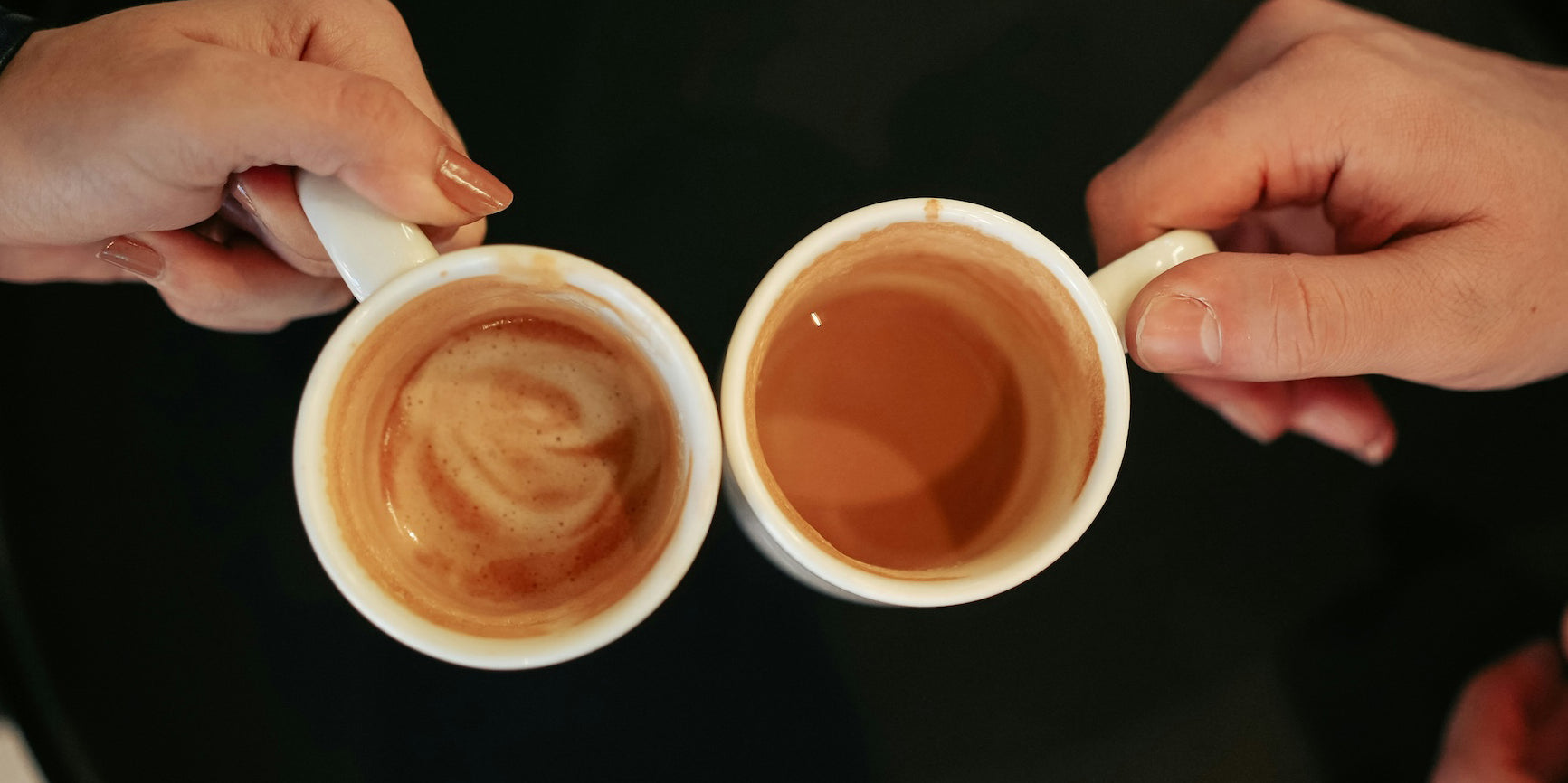 Two hands toasting with coffee mugs filled with freshly brewed Gigawatt Coffee, symbolizing connection and a great start to the day.