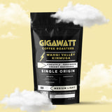 Gigawatt Coffee Wahgi Valley Papua New Guinea Coffee, freshly roasted, small batch medium light roast with smooth, balanced taste. Single origin from Papua New Guinea, 10 oz, set against a cloud-filled background.